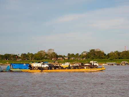 Santa Rosa, Peru - Dec, 2017: Transportation many cars across the Amazon River on the floating platform. Amazon River, Amazon. Border of Colombia, Brazil and Peru, Latin Americaのeditorial素材