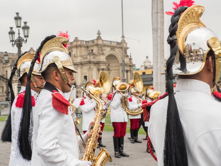 Lima, Peru - December 12, 2019: Close up for the man playing the golden saxophone. The guards of the Presidential Palace give a concert in the Plaza de Armas before the ceremony changes. South Americaのeditorial素材