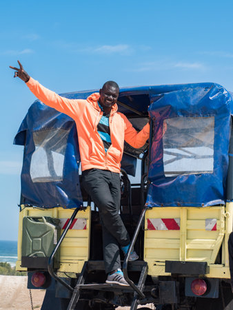 Senegal, Africa - Feb, 2019: Man in the car at the top of the hil. Road through the desert at the...