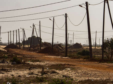 Electric pylons in a field in the suburbs of Dakar, Senegal, Africa.の写真素材