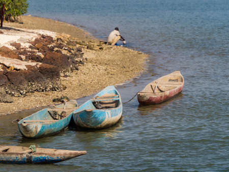 Joal-Fadiouth, Senegal - Jan 2019: Small wooden boats in the sea between Joel and Fadiouth - next to the island of seashells. Africaのeditorial素材