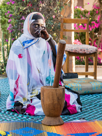 Senegal, Africa - Jan, 2019: Portrait of a beautiful Senegalese woman in a traditional costume called 'boubou' and a swing on her headのeditorial素材