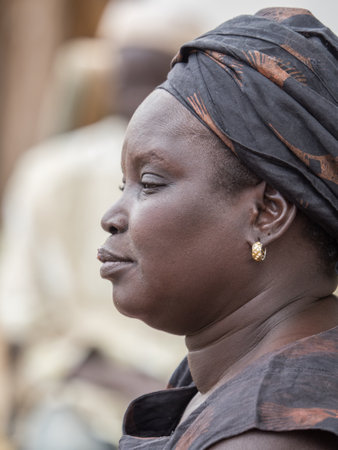 Senegal, Africa - Jan, 2019: Portrait of African woman in a traditional costume called 'boubou' and a swing on her headのeditorial素材