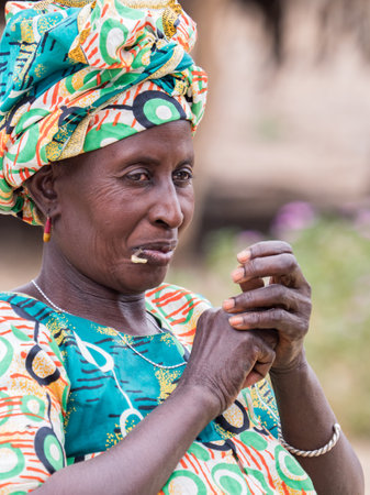 Senegal, Africa - Jan, 2019: Portrait of African woman in a traditional costume called 'boubou' and a swing on her headのeditorial素材