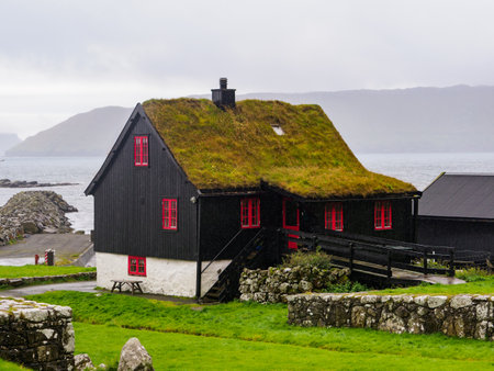 KirkjubÃ¸ur, Faroe Islands - October 2020: Typical wooden turf house with red window on Streymoy Island., Denmark, Northern Europeのeditorial素材
