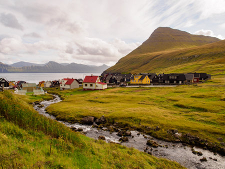 GjÃ³gv, Faroe Islands - Sep -2020: Colorful wooden houses along the watercourse called DalÃ¡. Gjogv village is located on the northeast tip of the island of Eysturoy, Denmark, Northern Europeのeditorial素材