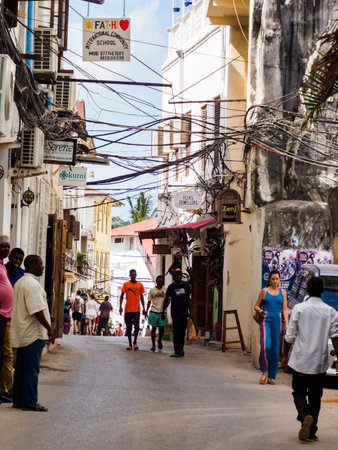 Stone Town, Zanzibar, Tanzania - Jan 2021: People on the narrow street of Stone Town. Africa.のeditorial素材