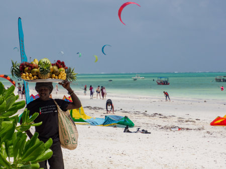 Paje, Zanzibar, Tanzania - January 202: African man with a tray full of exotic fruits on his head....