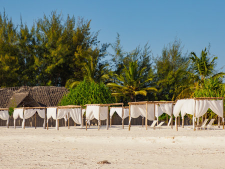 Sun loungers covered with white, airy curtains in a luxurious resort by Kae Beach on Chwaka Bay. Zanzibar Archipelago, Tanzania, Africaのeditorial素材