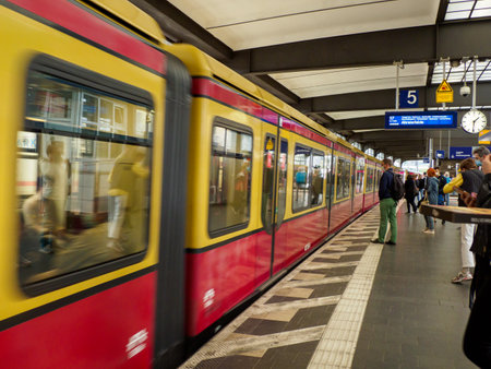 Berlin, Germany- Aug 2020: Traditional yellow red S-Bahn city trains in Berlin arriving Berlin Zoo (Zoologische Garten) Station. Europeのeditorial素材