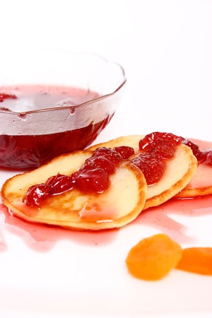 pancakes with strawberry jam on white backgroundの写真素材