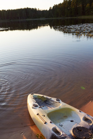 Kayak on the bank of the lake in the evening. Finland