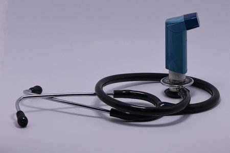Stethoscope with a salbutamol inhaler on the diaphragm - diagnosis and treatment in one picture.の写真素材