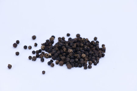 Black pepper on a white background - close up photography.の写真素材