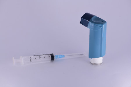 Salbutamol inhaler with 5ml empty syringe -product photogrpahy.の写真素材