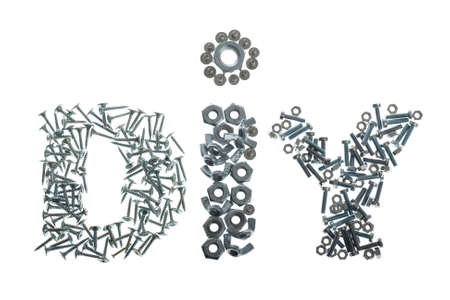 DIY label spelled out with screws, bolts and nuts isolated on white backgroundの写真素材
