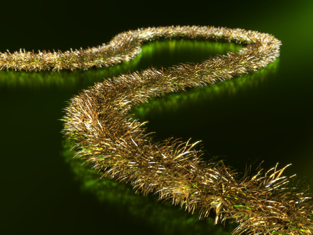 Close-up of a golden garland on green backgroundの写真素材