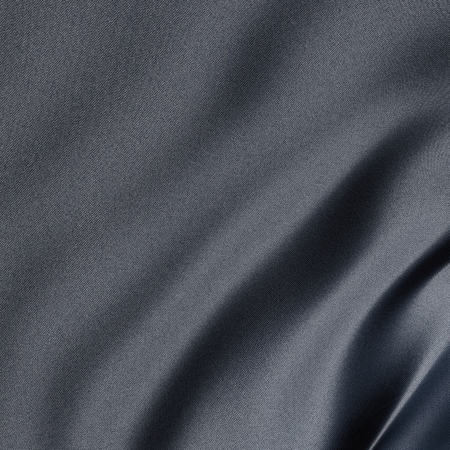 Close-up on a gray sheet with a light blue reflectionの写真素材