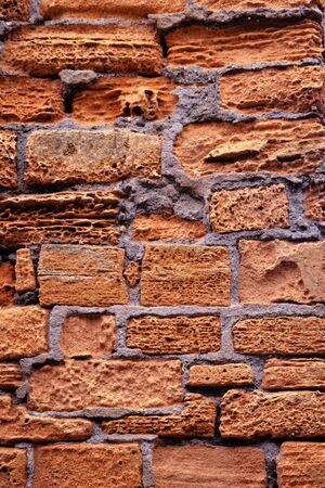 weathered orange brown brick wall textureの写真素材