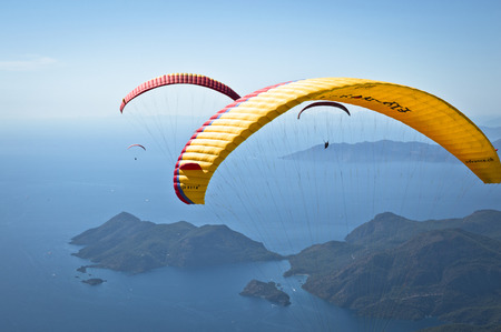 Fethiye, Turkey - September 6, 2013: Paragliding at Fethiye Oludeniz. Paragliding is a free flying sport where the pilot launches themselves by foot.のeditorial素材