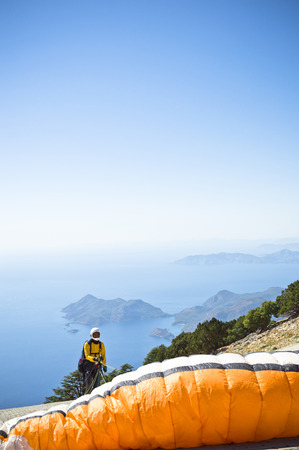 Fethiye, Turkey - September 6, 2013: Paragliding at Fethiye Oludeniz. Paragliding is a free flying sport where the pilot launches themselves by foot.のeditorial素材