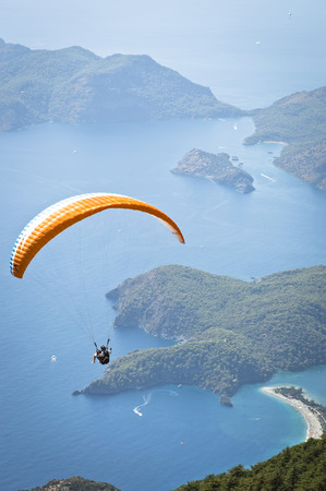 Fethiye, Turkey - September 6, 2013: Paragliding at Fethiye Oludeniz. Paragliding is a free flying sport where the pilot launches themselves by foot.のeditorial素材