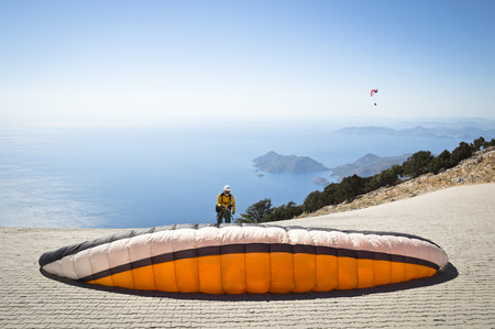 Fethiye, Turkey - September 6, 2013: Paragliding at Fethiye Oludeniz. Paragliding is a free flying sport where the pilot launches themselves by foot.のeditorial素材