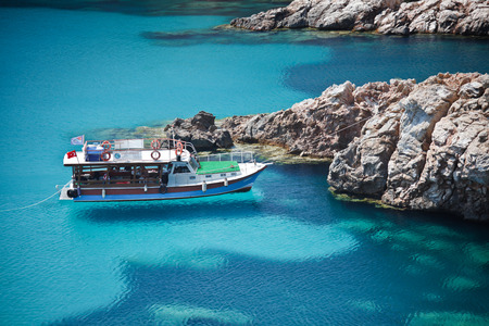 Bozcaada-Ãanakkale, Turkey - July 14 2011: Tourists on a boat arriving at a turquoise Bozcaada beach. Bozcaada is a very famous travel destination in the Aegean Sea.のeditorial素材