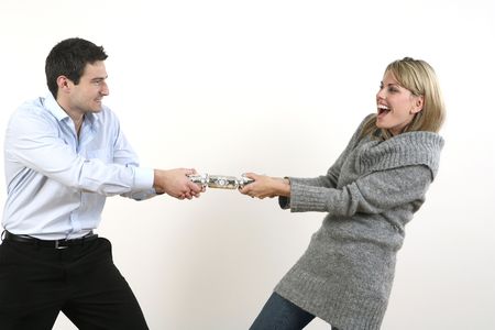 Man and woman pulling christmas crackerの写真素材