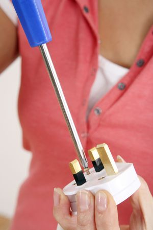 Woman fixing an electric plugの写真素材