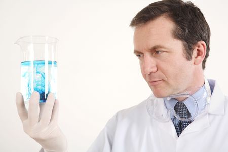 Man examining liquid in a beakerの写真素材