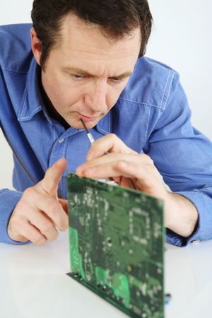 Man examining a computer circuit board