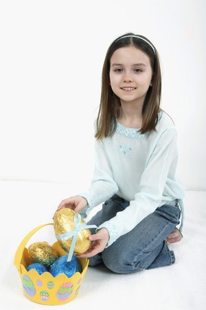 Girl holding Easter egg from Easter basket