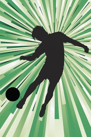 Silhouette of a footballer kicking a ballの写真素材