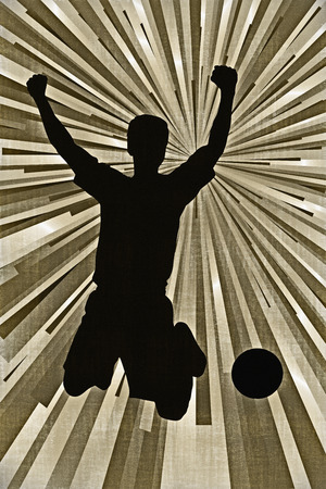 Silhouette of a footballer celebratingの写真素材