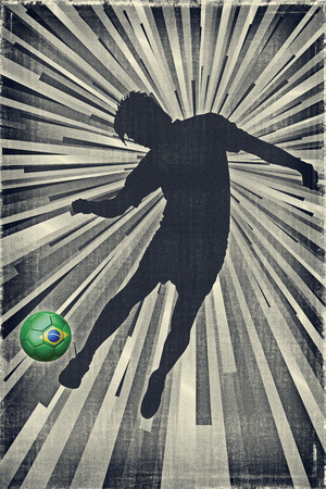 Silhouette of a footballer kicking a Brazil flag ballの写真素材