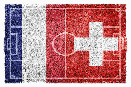 Flags of France and Switzerland on soccer fieldの写真素材