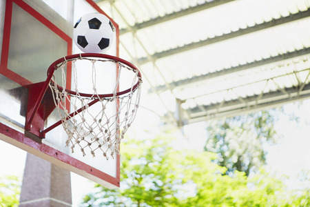 Playing basketball with soccer ballの写真素材