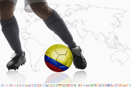 Soccer player dribble a soccer ball with Colombia flagの写真素材