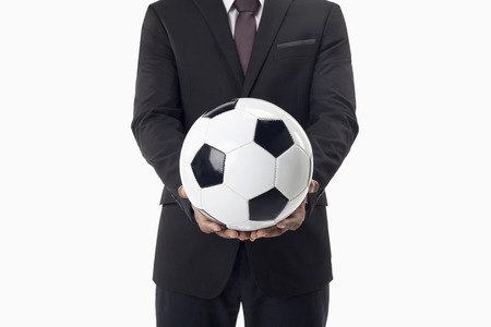 Soccer manager holding a ballの写真素材