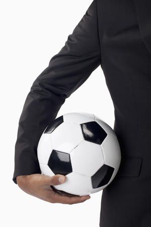 Soccer manager holding a ballの写真素材