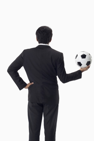 Soccer manager holding a ballの写真素材