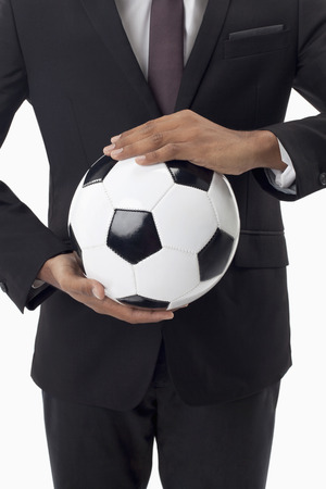 Soccer manager holding a ballの写真素材