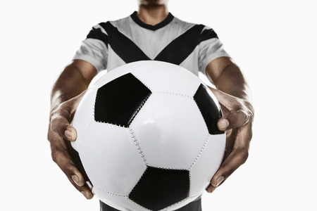 A soccer player holding a ballの写真素材