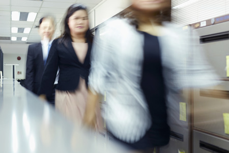 Blur motion of businessman and businesswoman walking