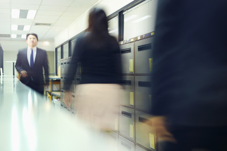 Blur motion of businessman and businesswoman walkingの写真素材