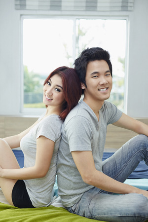 Couple leaning on each other backsの写真素材