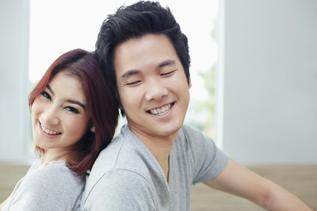 Couple leaning on each other backsの写真素材