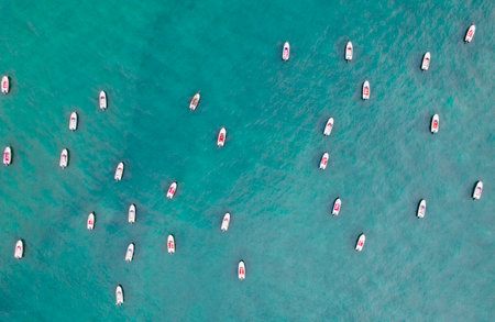 Vessels and speedboats moored on the sea