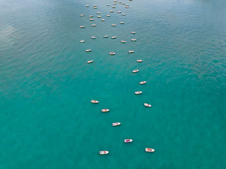 Vessels and speedboats moored on the seaの写真素材